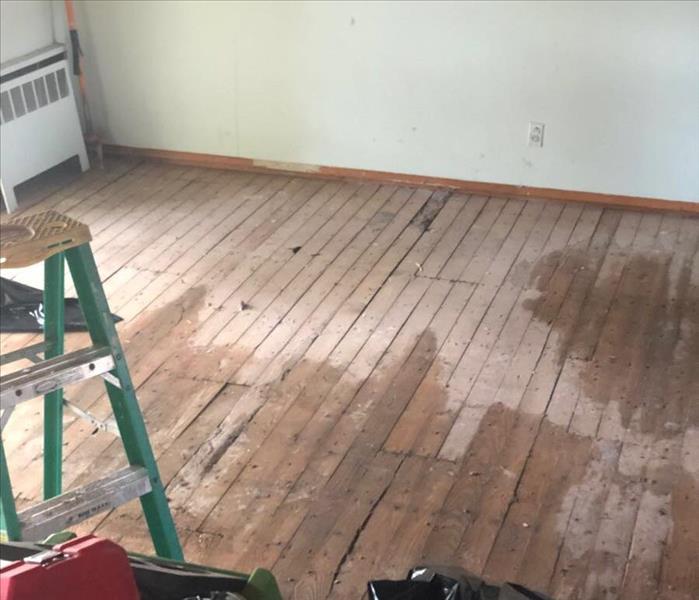 water and moisture on rough plank flooring, heater on wall