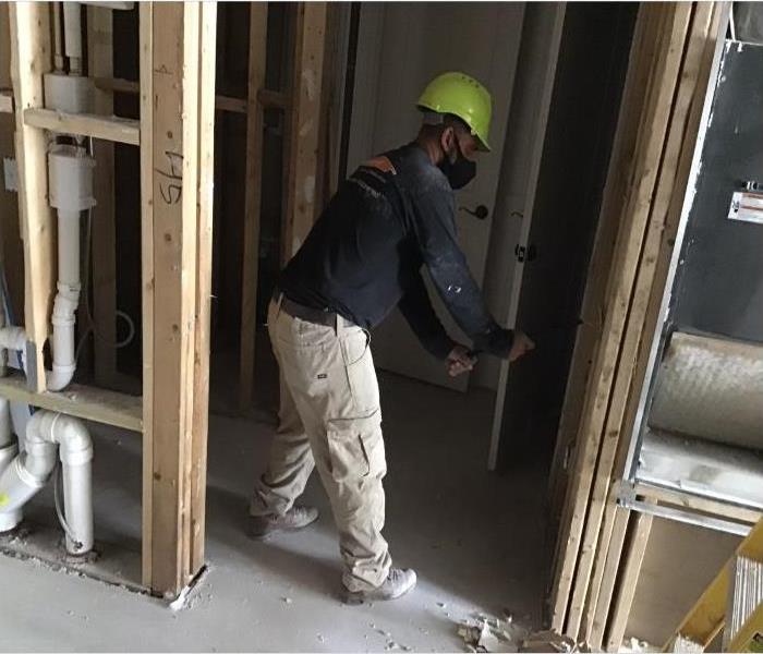 technician removing drywall 