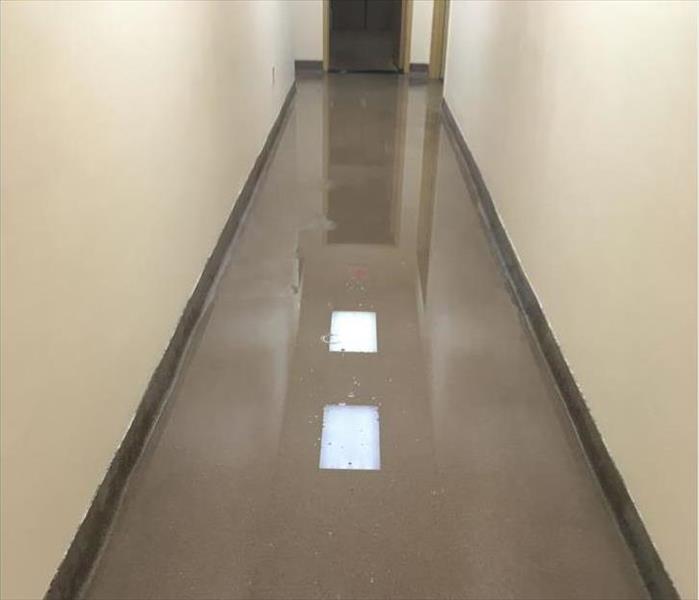 water reflecting off ceiling lights in a corridor