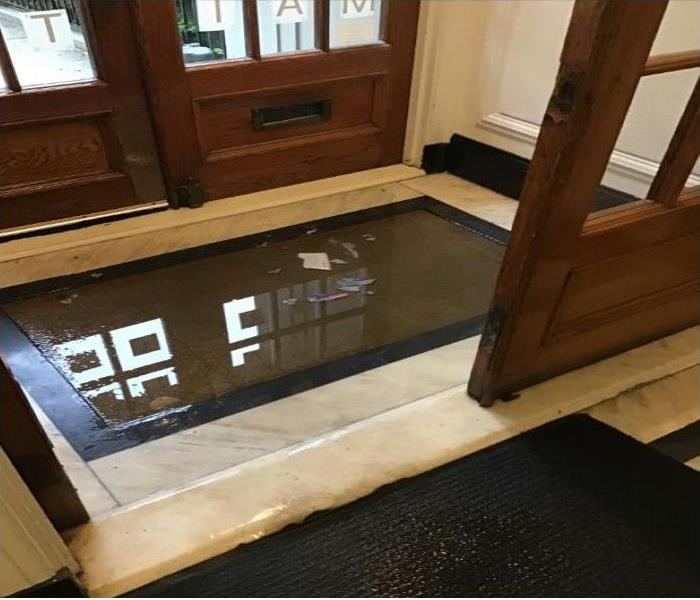 puddle of water in entrance of building