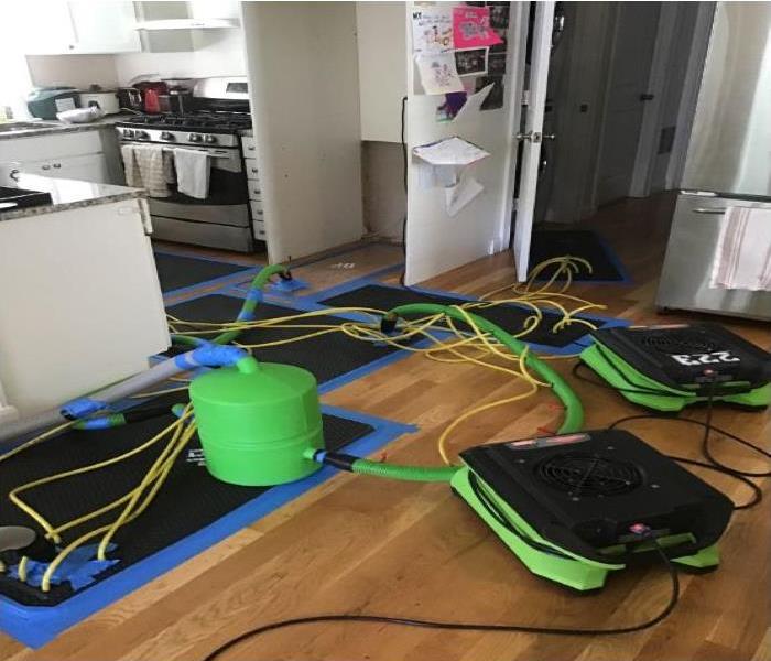 green equipment and drying mat in kitchen