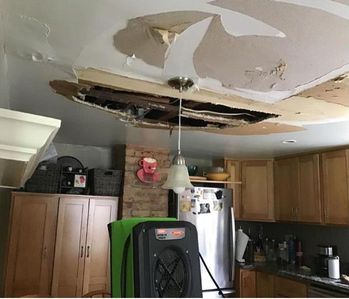 green drying equipment in kitchen with missing ceiling 